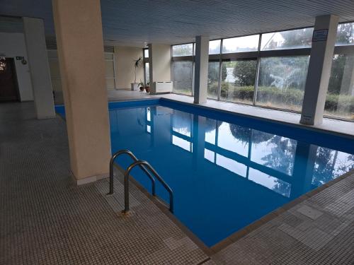 Ferienwohnung Nähe Flughafen mit Schwimmbad und Sauna في مورفلدن فالدورف: مسبح كبير بالدور الأزرق ونوافذ