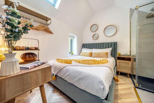 a bedroom with a bed and a glass shower at Birch Studio in Camborne