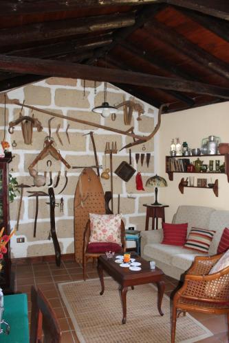 a living room filled with furniture and a wall with antlers at Casa Rural Anton Piche with Pool-Adults Only in Granadilla de Abona