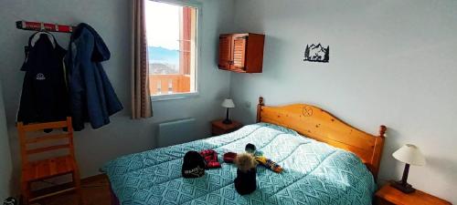 a bedroom with a bed with a stuffed animal on it at Vue panoramique - Confortable - Piscine - Randonnées - Skis in Font Romeu Odeillo Via