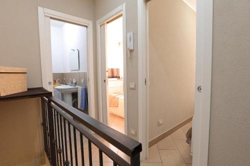 a hallway with a stairway leading to a bathroom at U Casteddu Home Motta Sant'Anastasia 1 in Motta SantʼAnastasia