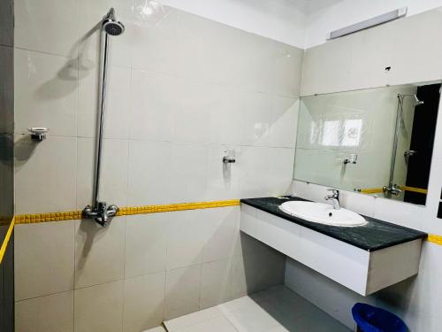 a bathroom with a sink and a mirror at OSMA Residency in Islamabad