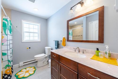 a bathroom with a sink and a mirror at Lakeview Family Retreat Newly Renovated 4BR House in Pocono Country Place