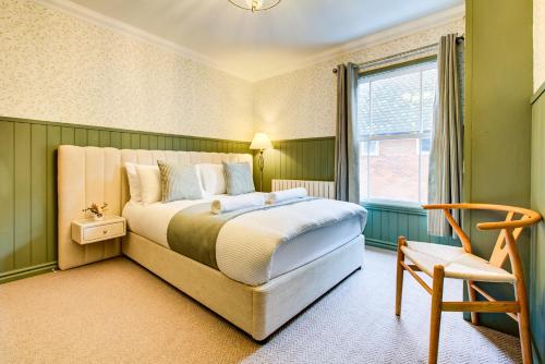 a bedroom with a bed and a window and a chair at Cottage in the centre in Colchester