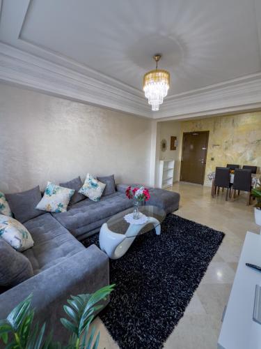 a living room with a couch and a table at artisanat in Mohammedia