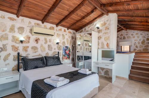 a bedroom with a bed and a tv at Villa Elvin in İslâmlar