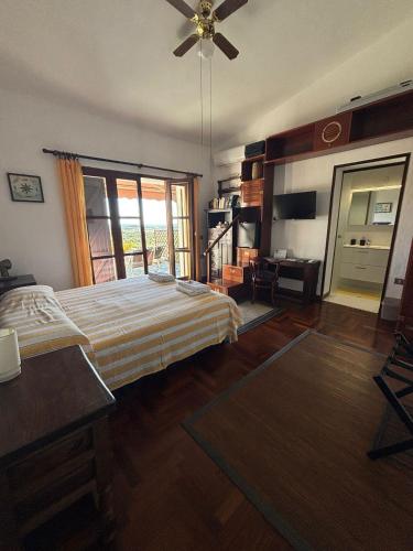 a bedroom with a bed and a ceiling fan at Villa delle torri in Pula