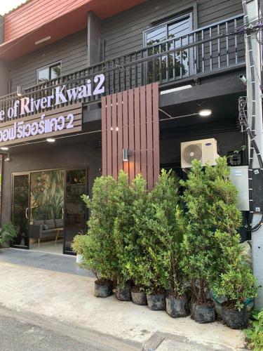 a building with a bunch of plants in front of it at Home of River Kwai 2 in Kanchanaburi City