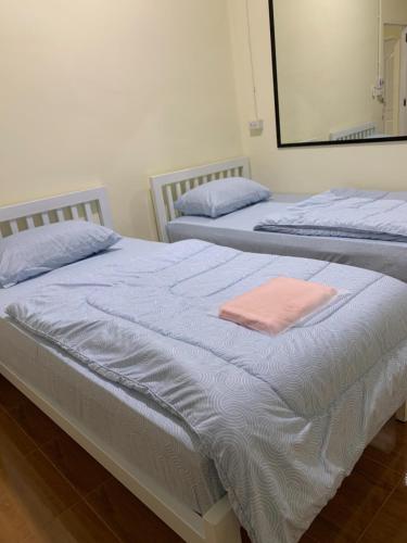 two beds sitting next to each other in a bedroom at Home of River Kwai 2 in Kanchanaburi City