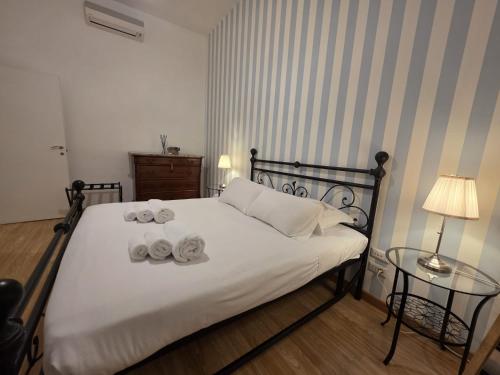 a bedroom with a bed with two towels on it at MR House - by Be Your Home in Rome