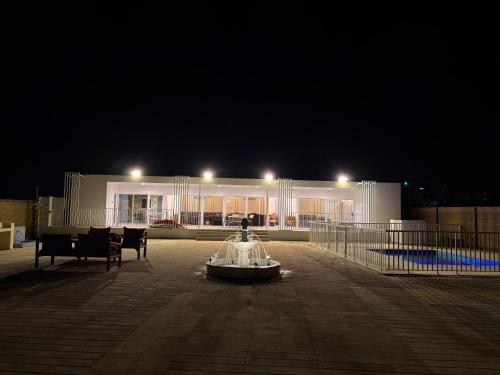 a building with a fountain in front of it at night at Alawadhi Farm 1 in Ras al Khaimah