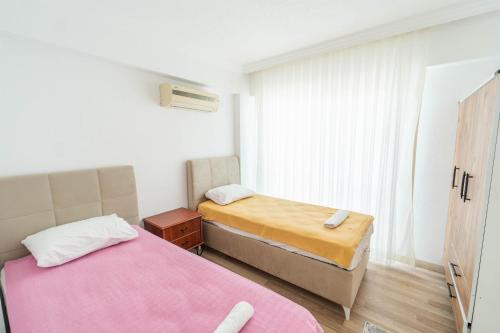 mała sypialnia z dwoma łóżkami i oknem w obiekcie Villa Sena w mieście Dalyan