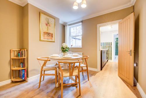 a dining room with a table and chairs at Cottage in the centre in Colchester