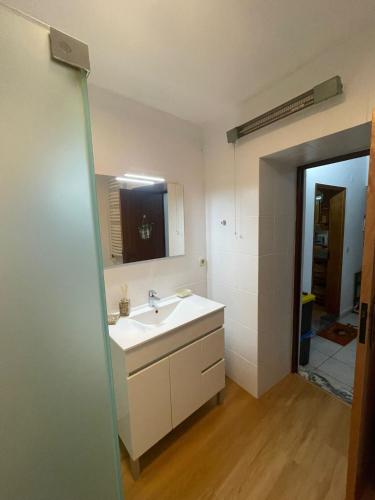 a bathroom with a sink and a mirror at Edu Stay Mondego in São Pedro de Alva
