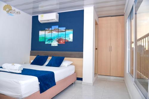 Postel nebo postele na pokoji v ubytování Hotel Perla del Caribe