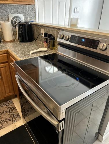 a kitchen with a stove top oven in a kitchen at Spacious 4BR Close to Airport for Work and Families in Columbus