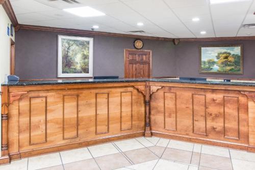 a bar in a room with wood paneling at Days Inn by Wyndham Columbus-North Fort Moore in Columbus