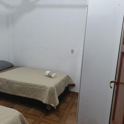 una piccola stanza con due letti e uno specchio di LA MAXIMIANa a Libertador General San Martín