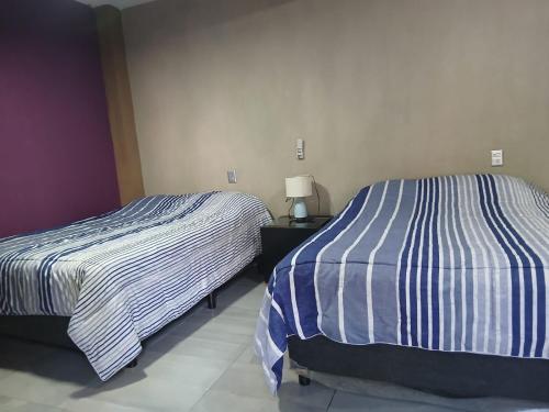 two beds sitting next to each other in a room at casa ex hacienda casasano in Cuautla Morelos