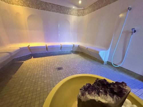 a bathroom with a cake on a yellow tub at Hotel Phönix in Bad Füssing