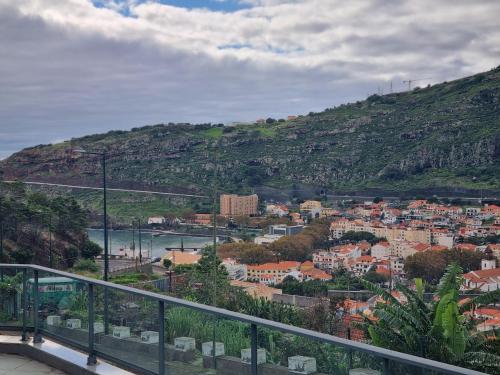 a view of a city with a hill at Apto Vista Baía Machico in Machico