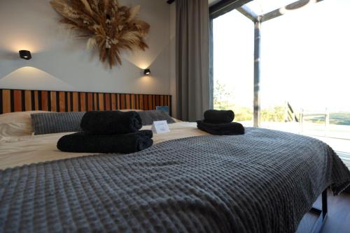 a bedroom with a large bed with towels on it at Ateliéry Nad Závozom in Hrušov