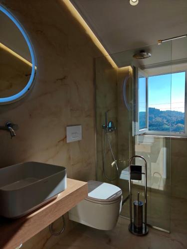 a bathroom with a sink and a toilet and a shower at Orion Palace Boutique Hotel in Durrës