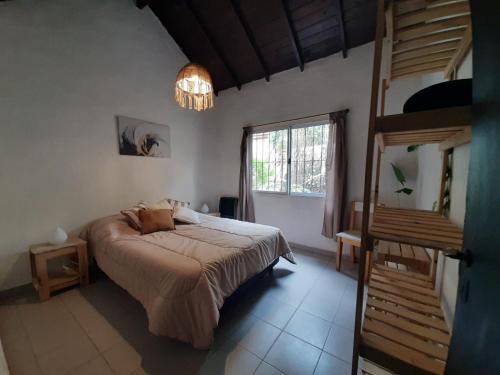 a bedroom with a large bed and a staircase at Buenas Ondas in Mar Azul