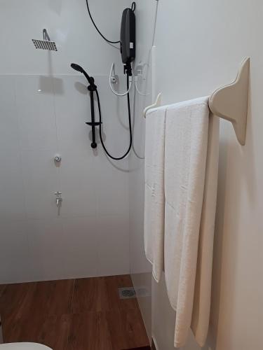 a bathroom with white towels hanging on a wall at Coastal Residence in Hikkaduwa