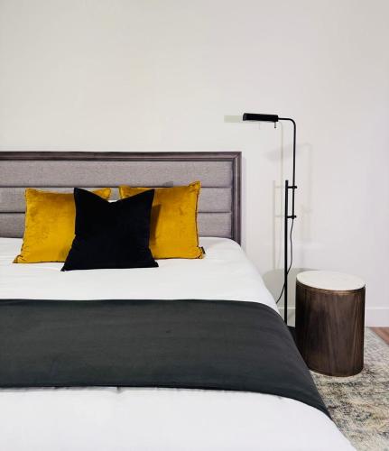 a bedroom with a white bed with yellow pillows at Modern King Room Private Ensuite Vancouver West in Vancouver