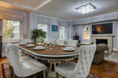 a dining room with a table and chairs at The Grande Mayfair Apartment in London