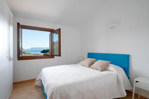 Ένα ή περισσότερα κρεβάτια σε δωμάτιο στο Villaggio Perlacea - Your House in Sardinia