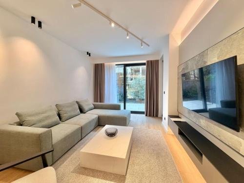 un soggiorno con un divano e una grande TV di Air Onia a Budua