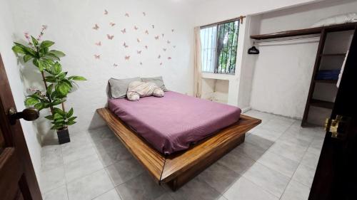 a bedroom with a bed with a stuffed animal on it at Familiar, amplio y con alberca in Puerto Vallarta
