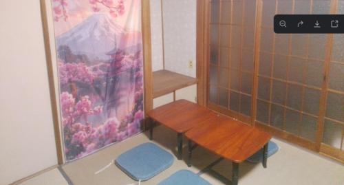 a small room with two benches and a table at ふるさと in Wada