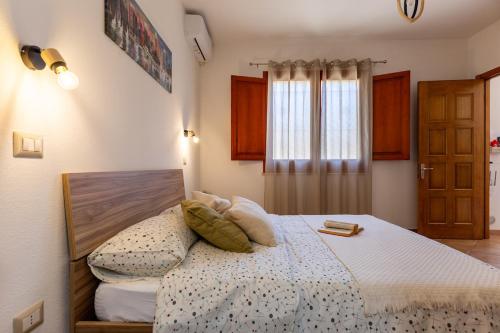 a bedroom with a bed with pillows on it at Casa Teo in Monastir