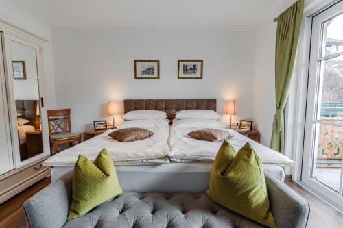 a bedroom with a large bed and two chairs at Villa Eisl-Raudaschl in St. Wolfgang