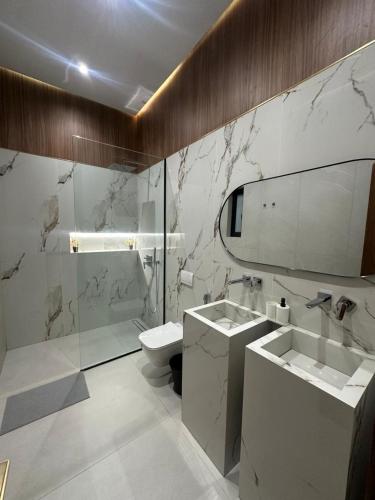 a bathroom with a sink and a toilet and a mirror at Luxury Villa Marrakech in Marrakesh