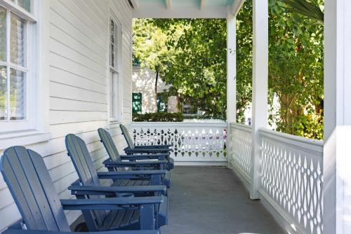 a row of chairs sitting on a porch at Sweet Caroline in Key West