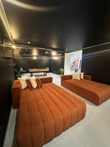 two beds in a room with a couch and a table at Luxury Villa Marrakech in Marrakesh