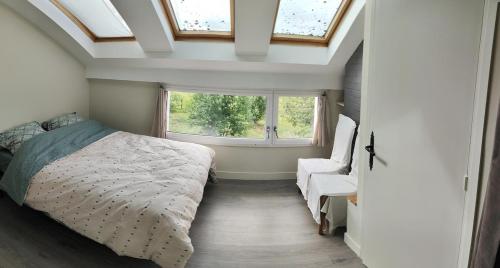 a bedroom with a bed and a window at Gite du bout là haut in Audincthum