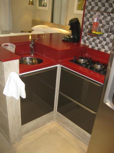 a small kitchen with a sink and a stove at Condo Prudente 108 in Rio de Janeiro