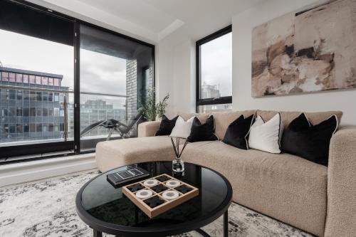a living room with a couch and a table at 2 Bedroom - Old Trafford - Balcony - Free Parking in Manchester