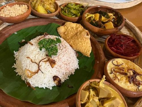 a plate of rice on a banana leaf with different foods at Himasha Guest in Mirissa