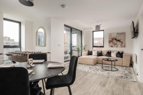 a living room with a couch and a table at 2 Bedroom - Old Trafford - Balcony - Free Parking in Manchester