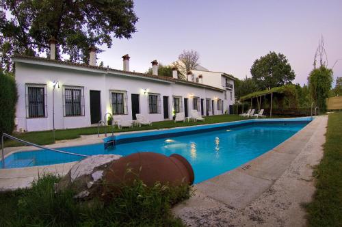 a house with a swimming pool in front of it at Hotel Galaroza Sierra in Galaroza