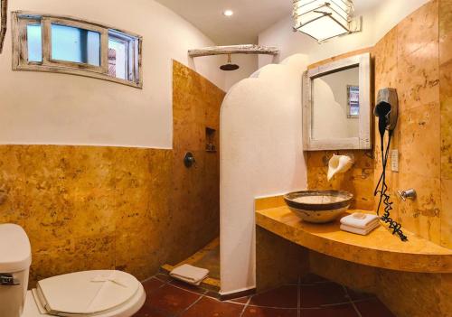 un baño con lavabo e inodoro en Holbox Dream Beachfront Hotel, en Isla Holbox