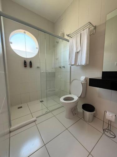 a bathroom with a shower and a toilet at Gran Carlo Hotel in Taubaté