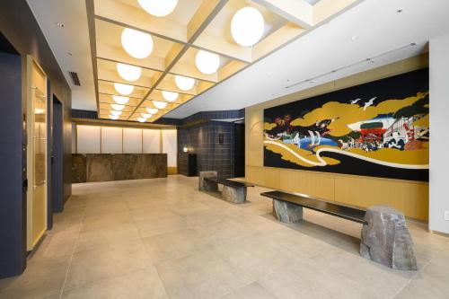 a lobby with a large painting on the wall at Richmond Hotel Asakusa in Tokyo