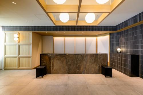 a large room with a table and lights on the ceiling at Richmond Hotel Asakusa in Tokyo